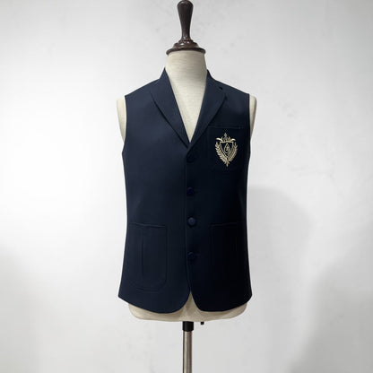Navy blue blazer with a crest on a mannequin against a white background